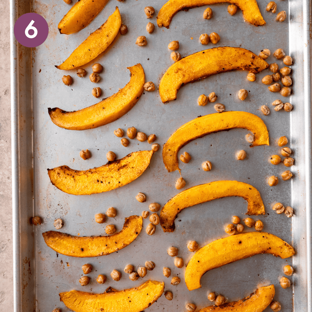 pumpkin and chickpeas on a baking sheet after being cooked.