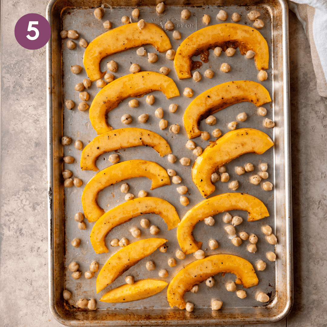 pumpkin and chickpeas on a baking sheet before being cooked.